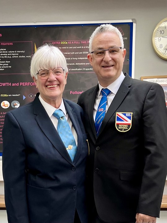 Dave stands with Carol Leverton after he is awarded National A referee badge